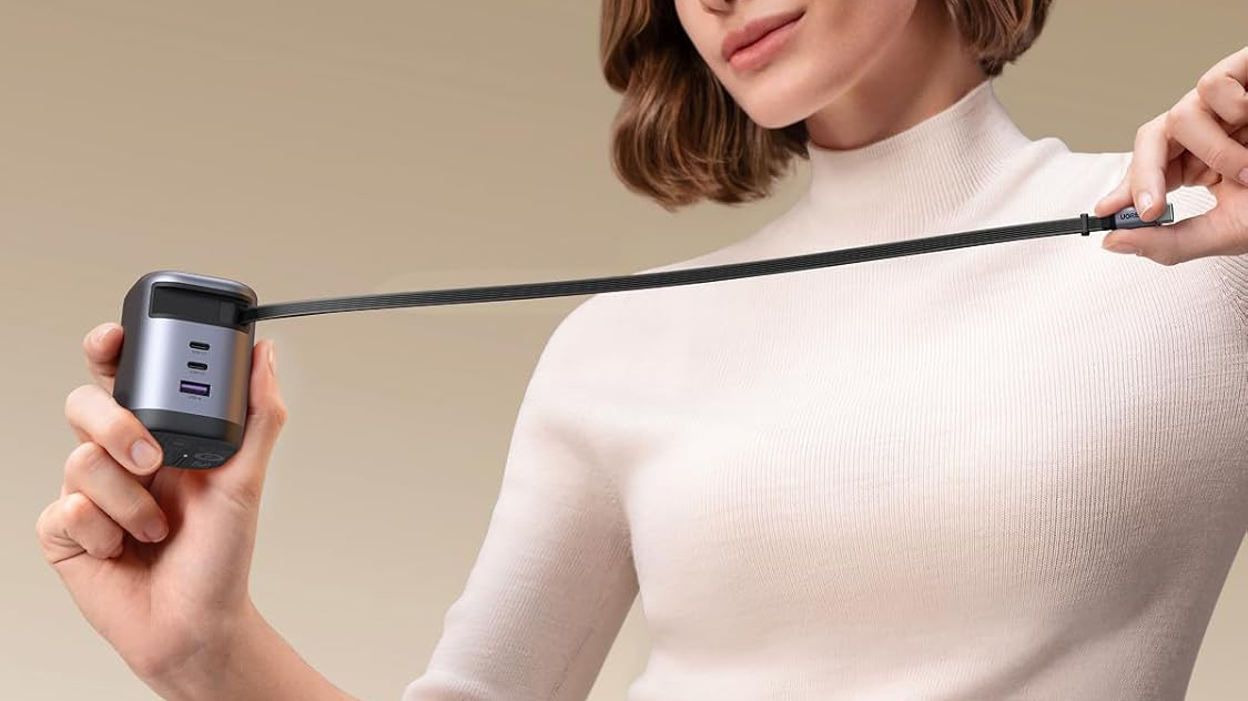 Woman holding UGREEN 100W 4 in 1 GaN USB C Charger with Retractable Cable