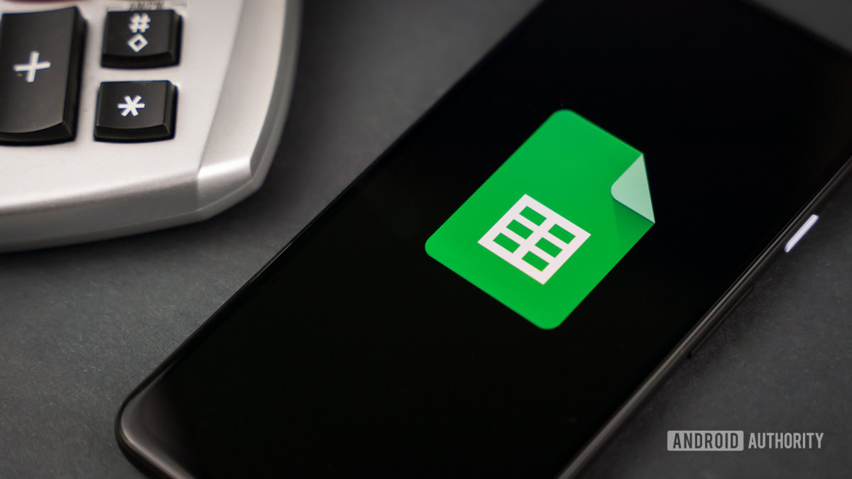 Google Sheets next to calculator stock photo 2