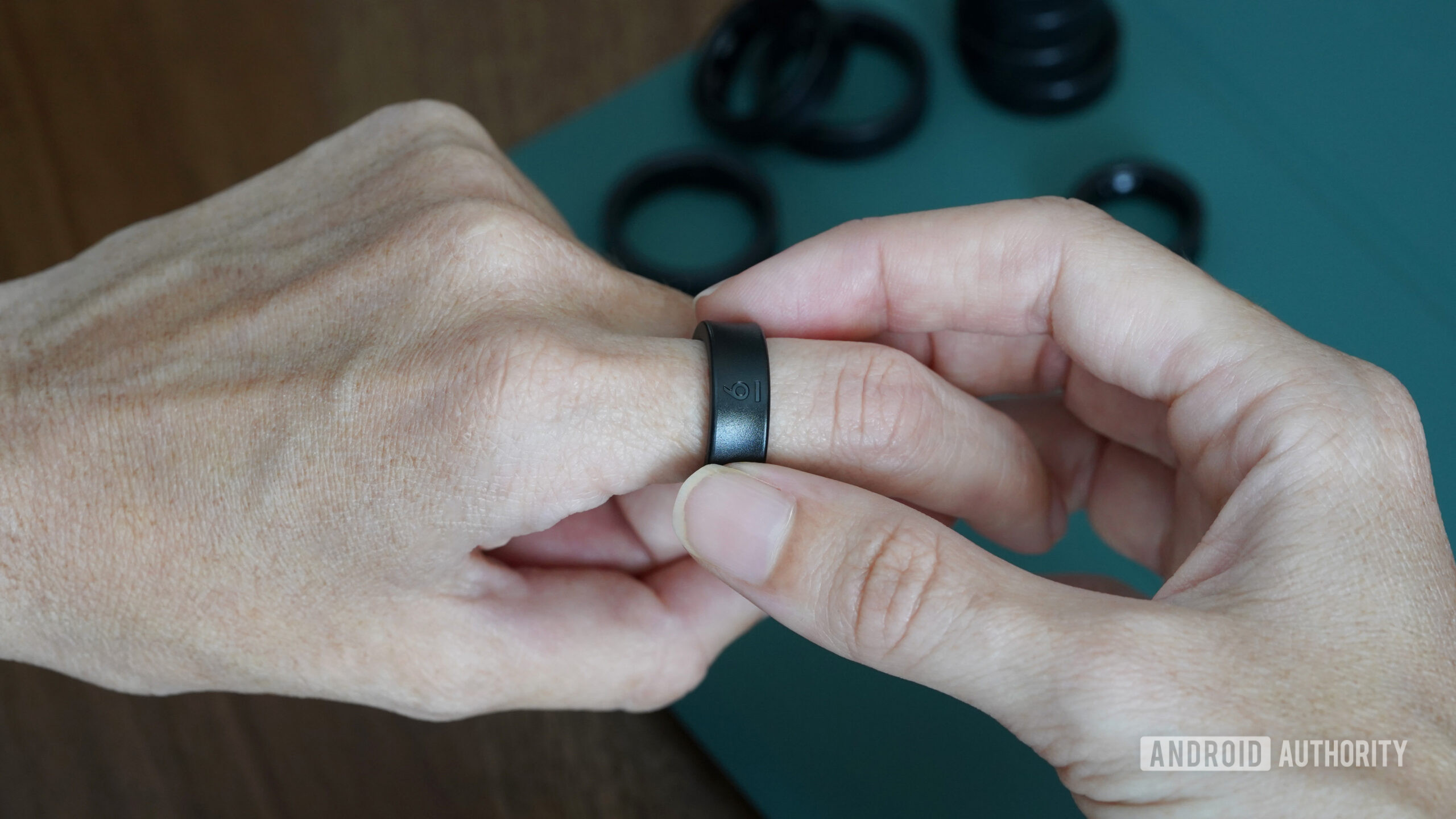A furture Samsung Galaxy Ring user tries on a size 6 from the sizing kit.
