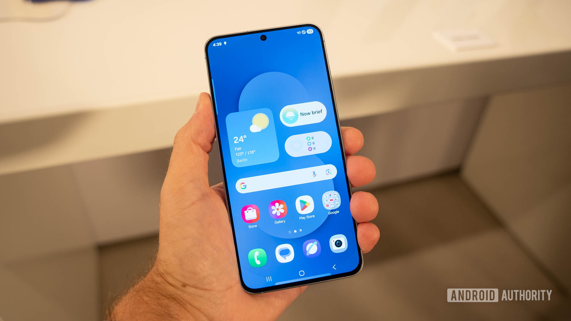 Samsung Galaxy S25 FE in man's hand showing home screen