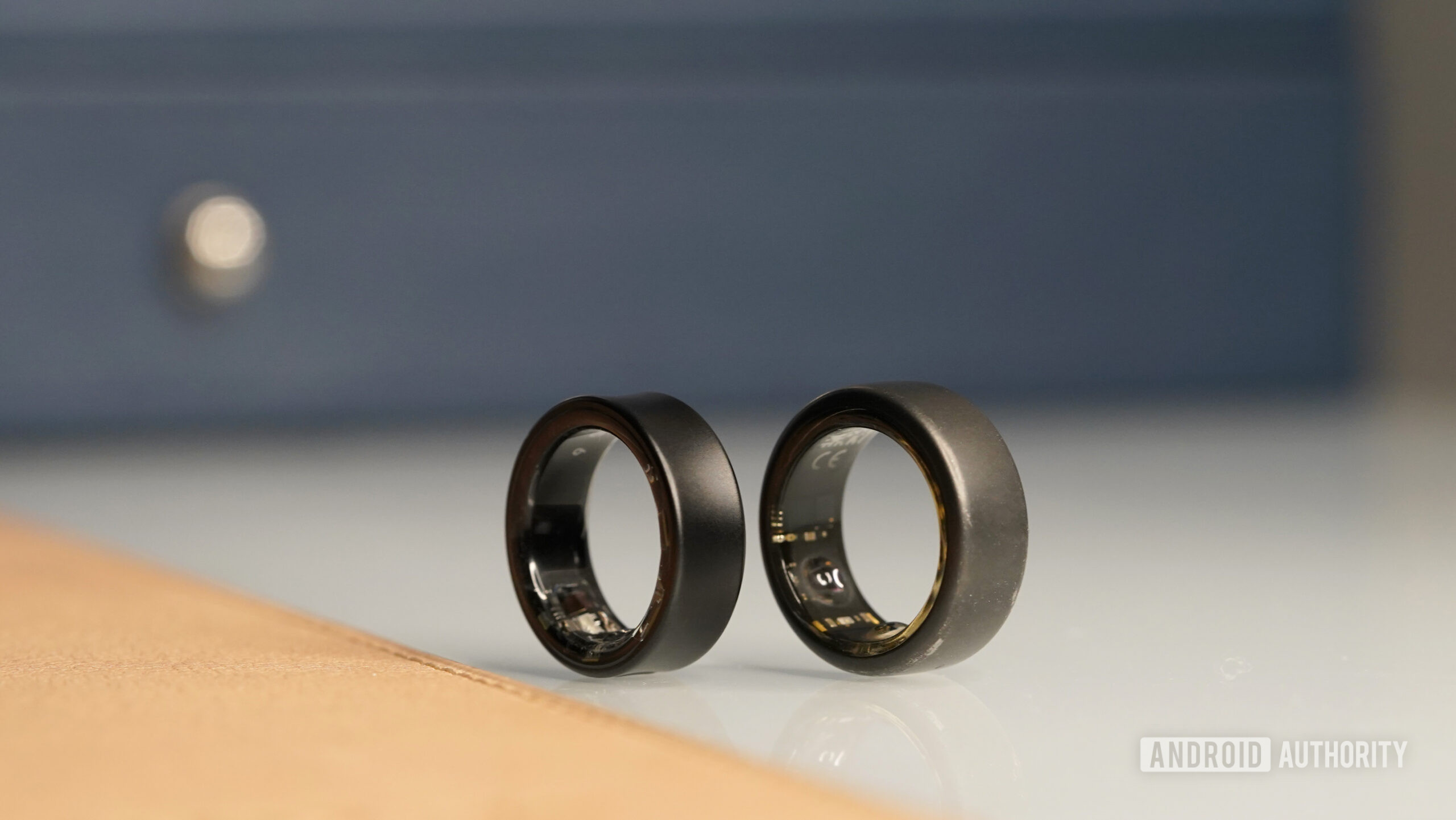 A Samsung Galaxy Ring and Oura Ring 3 stand side by side.