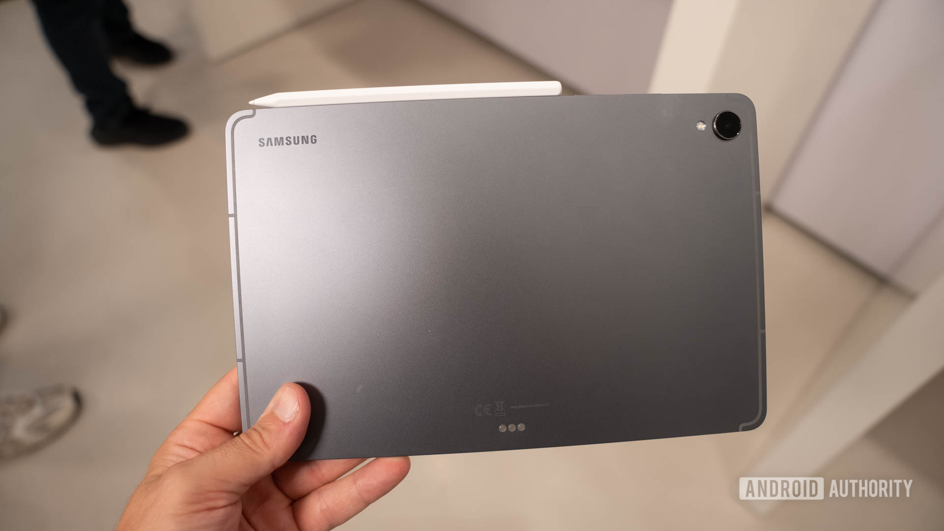 Samsung Galaxy Tab S11 in man's hand showing back