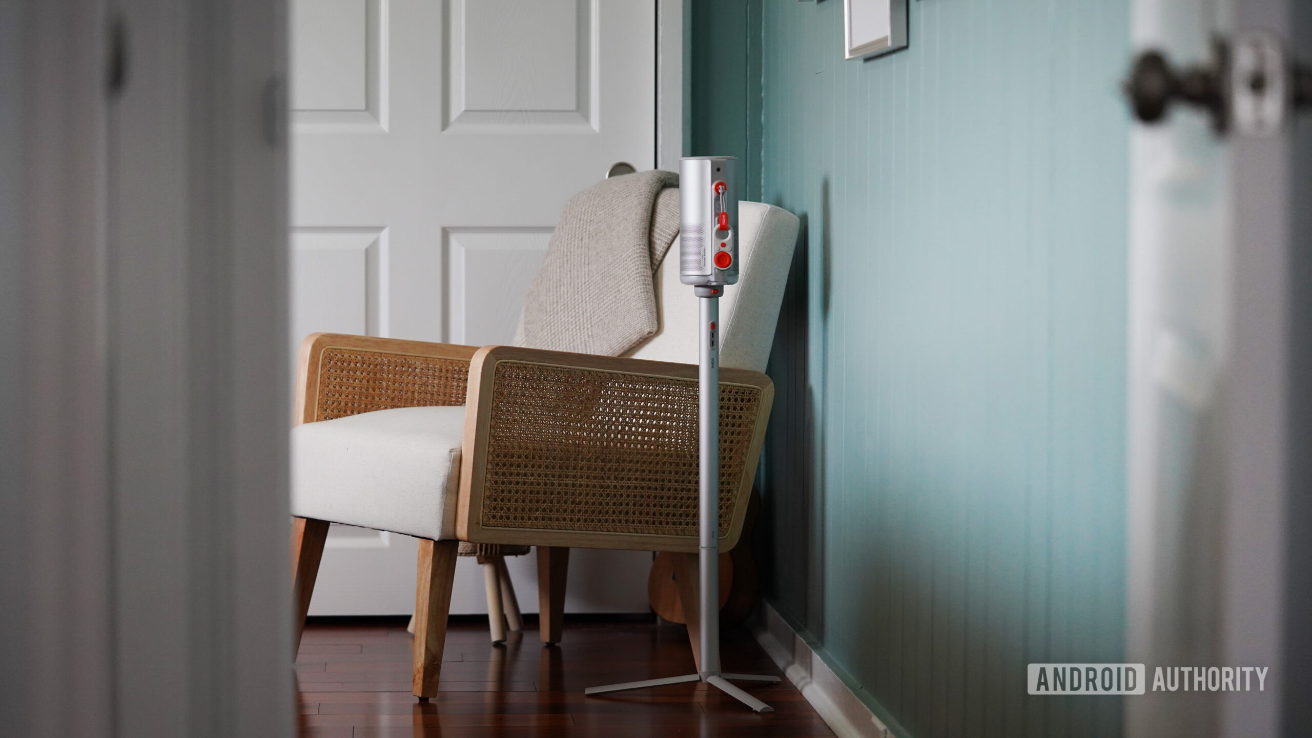 An XGIMI Mogo 4 is tucked into the corner of a bedroom.