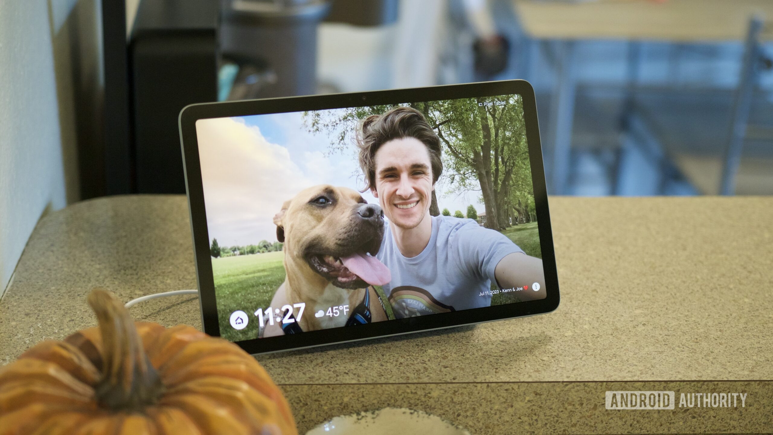 The Google Pixel Tablet attached to its speaker dock, sitting on a kitchen counter.