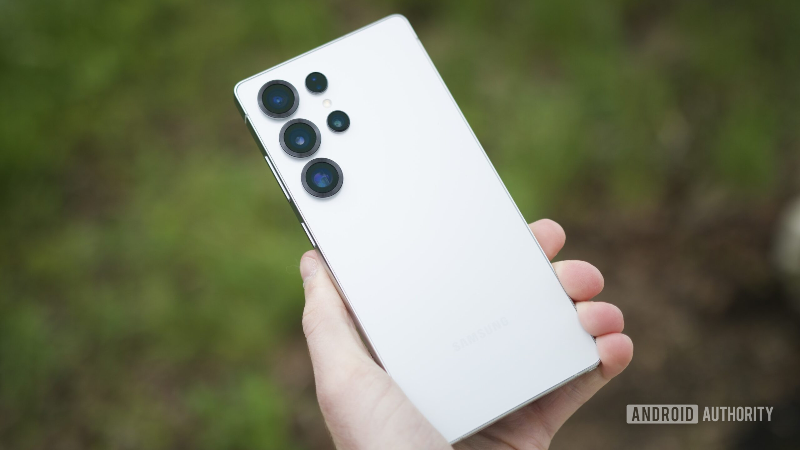 Someone holding the Samsung Galaxy S25 Ultra, showing the back of the phone.