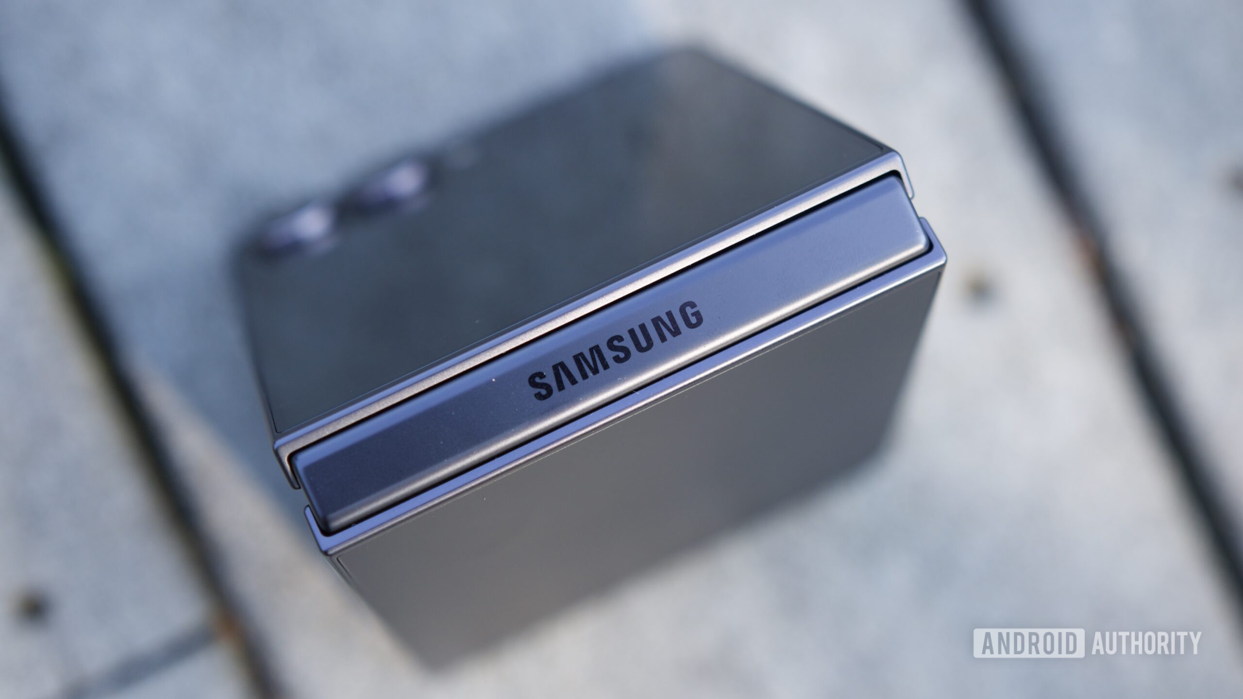 Close up view of the Samsung logo on the Galaxy Z Flip 7 hinge.