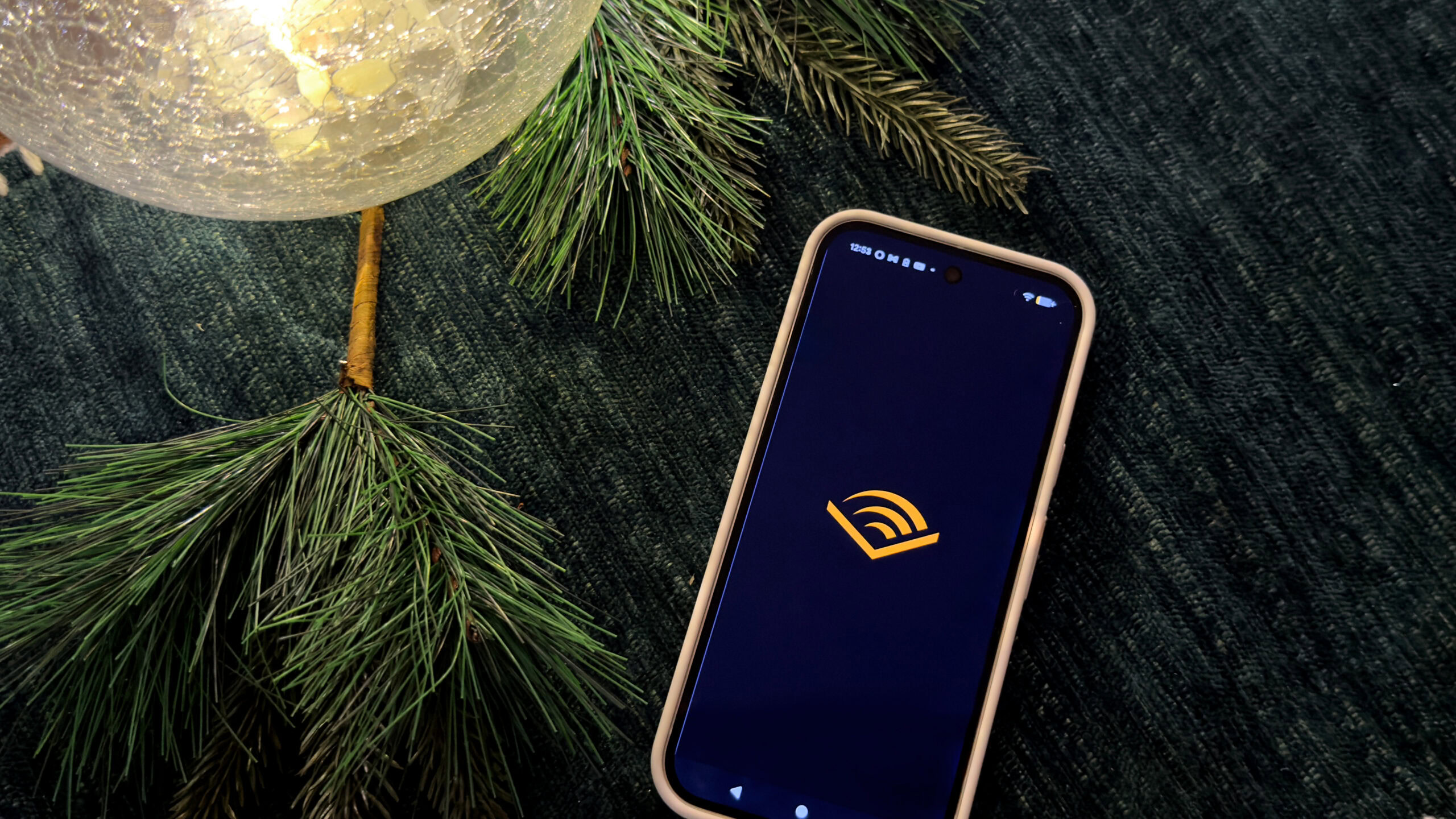 A Google Pixel 9 displays an Amazon Audible logo.