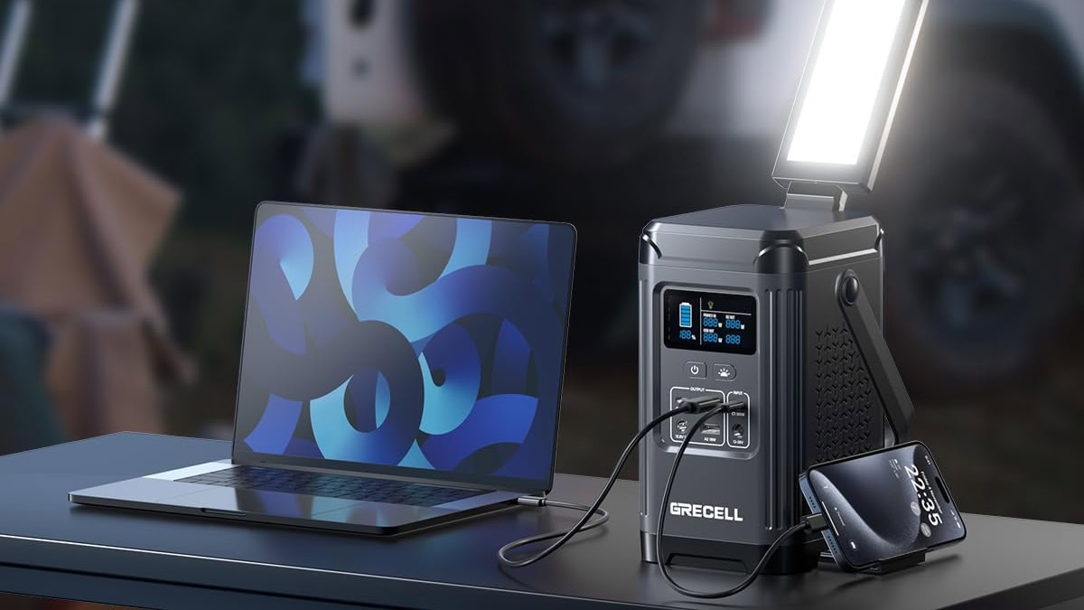 GRECELL 240W Portable Power Station on table charging laptop