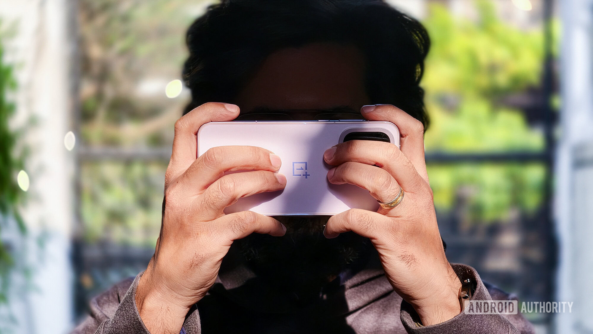 oneplus 15 purple held to face