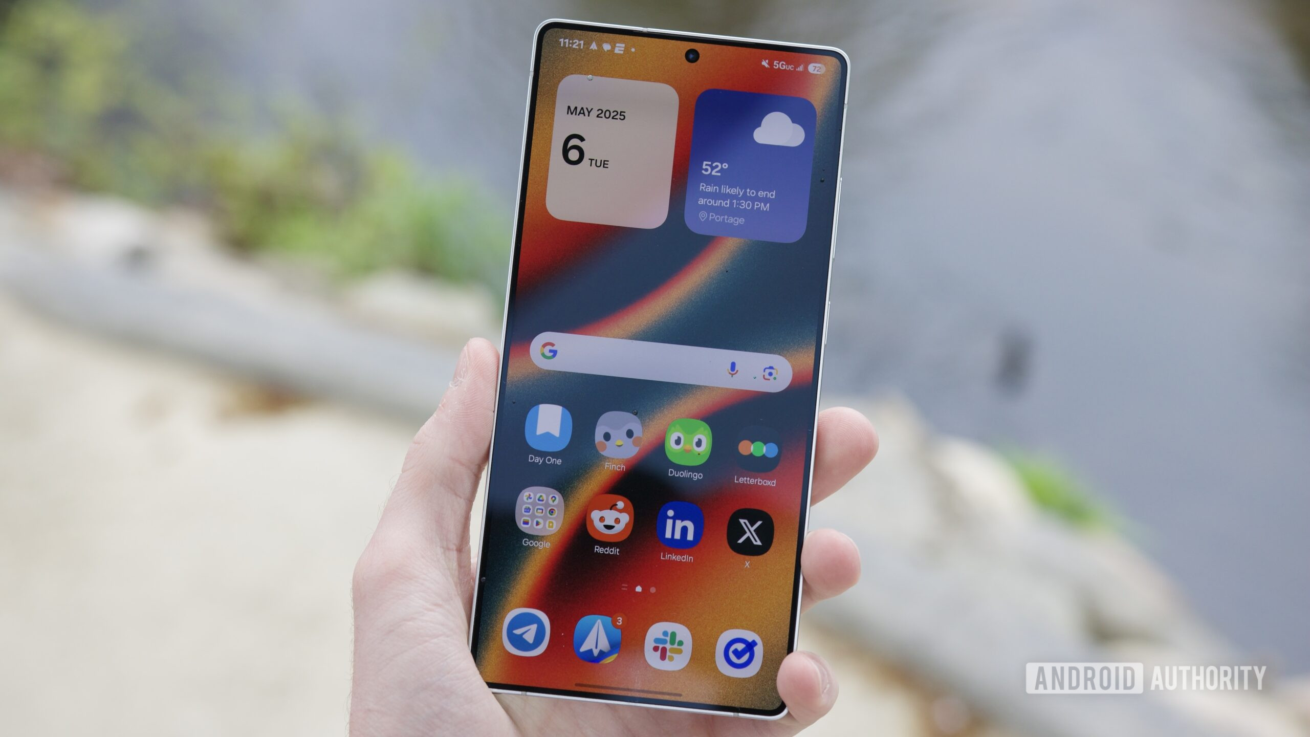 Someone holding the Samsung Galaxy S25 Ultra with its display turned on.