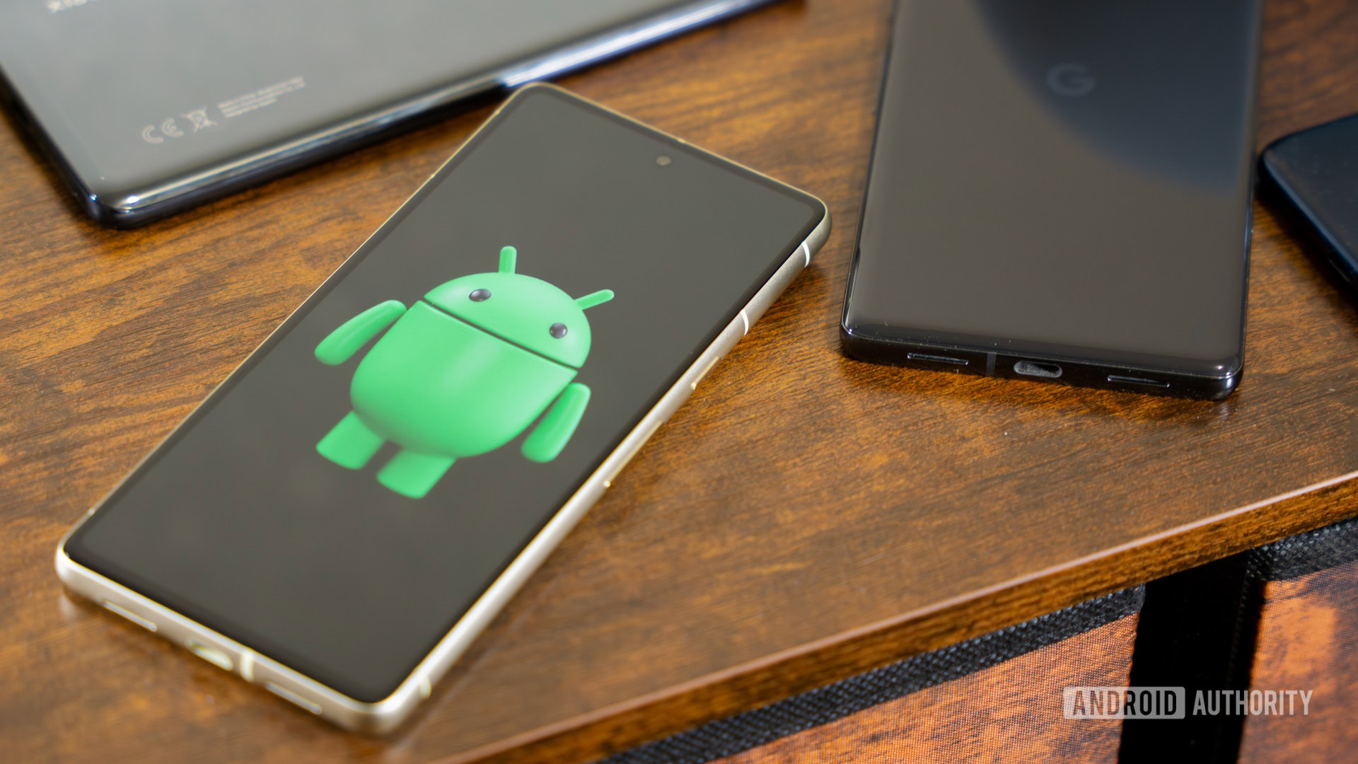 Android robot on smartphone next to other devices and accessories (4)