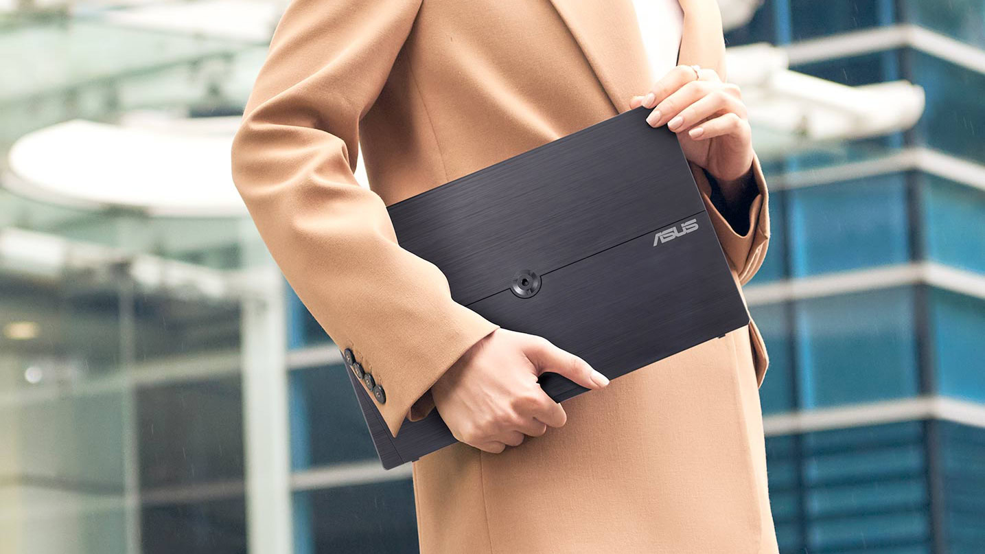 Person in suit carrying ASUS ZenScreen 16 Inch Portable Monitor (MB16AHV)