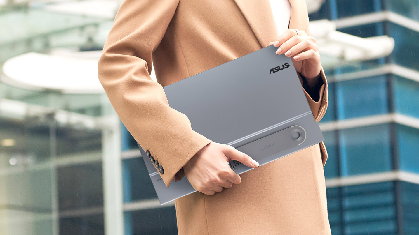 Person in suit with ASUS ZenScreen 16” OLED (MQ16AHE) portable monitor