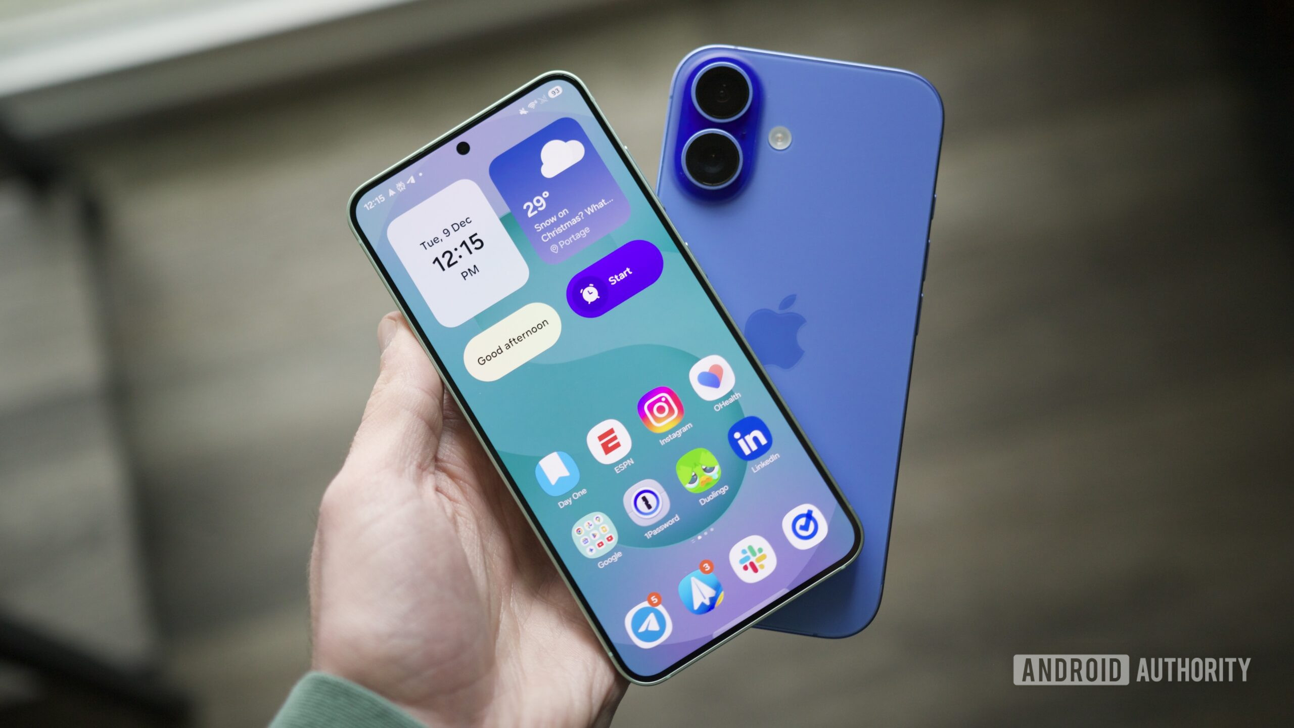 Someone holding a Galaxy S25 and an iPhone.