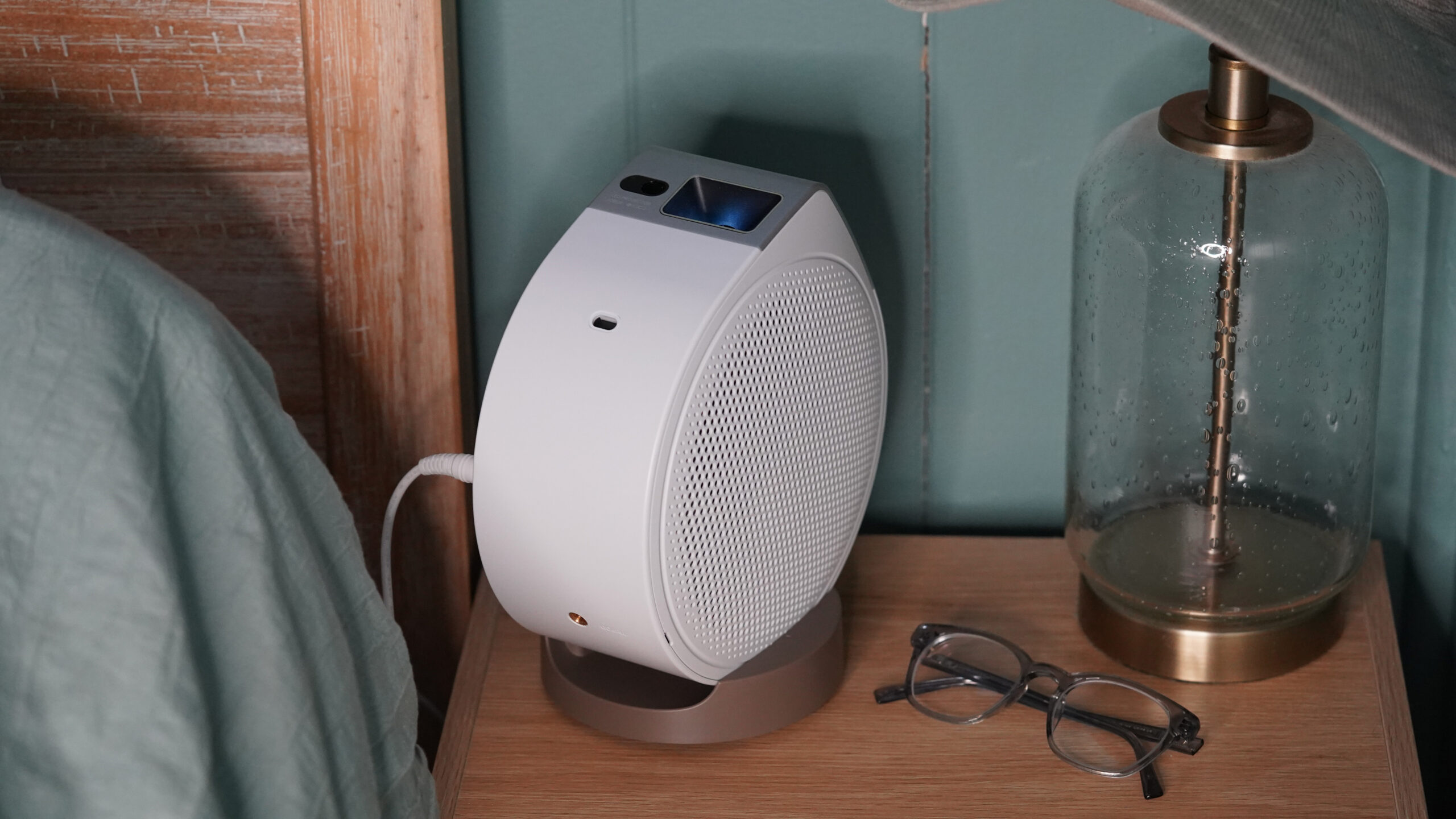 A BenQ GV32 rests on a user's nightstand.