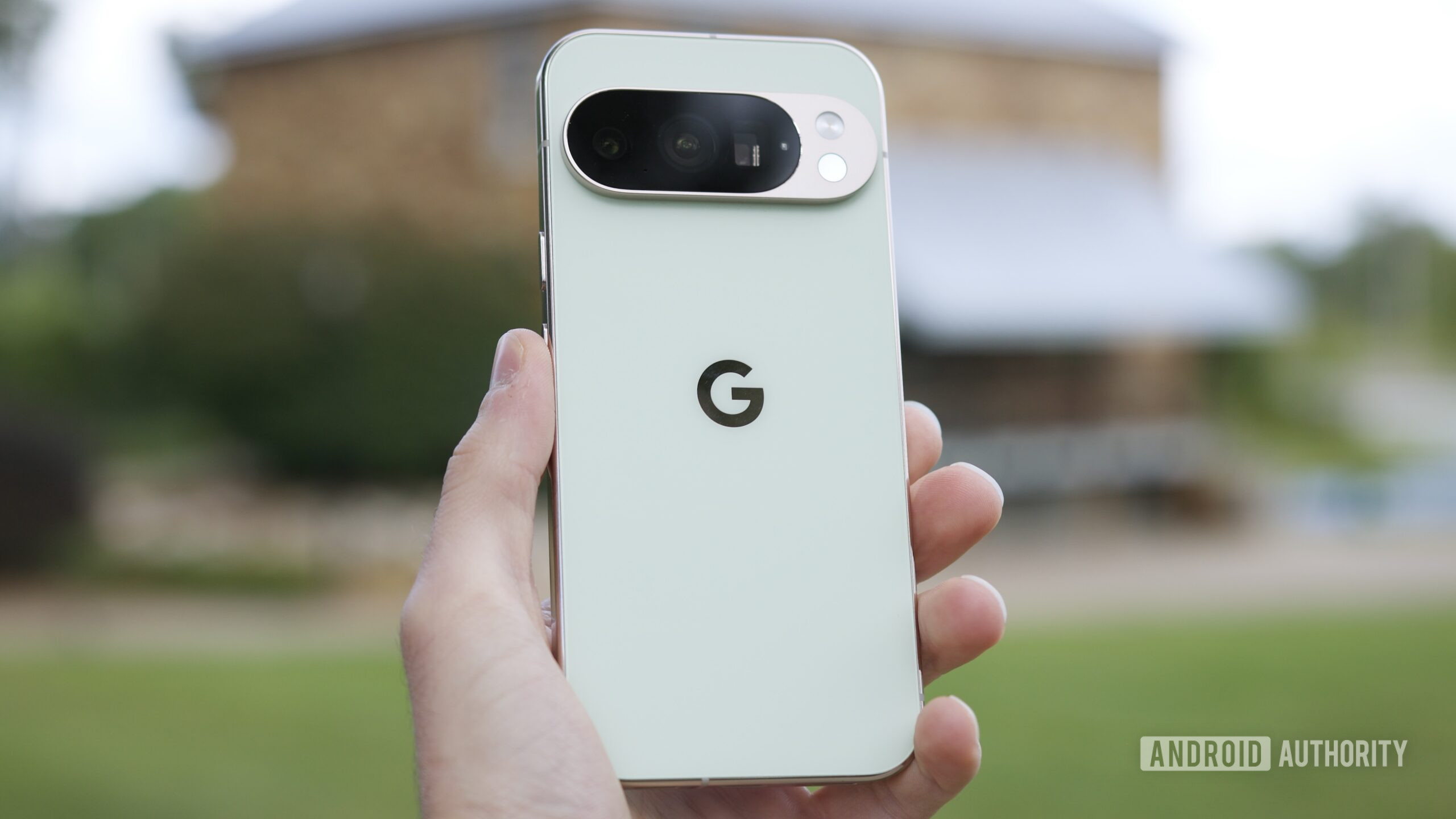 Someone holding the Google Pixel 10 Pro outside.